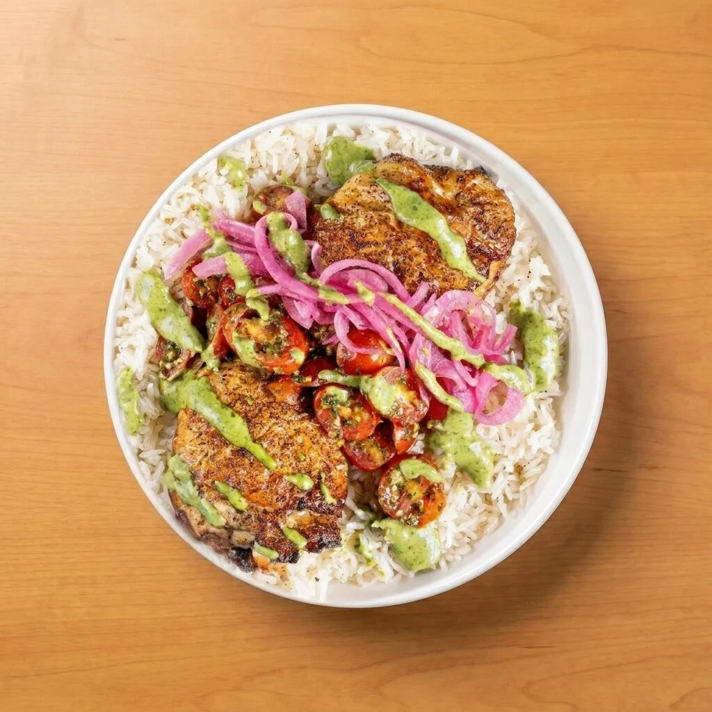 Taste the RainBol: Jasmine rice and rotisserie chicken thigh, topped with chimichurri tomatoes, pickled red onions, and herb pesto.