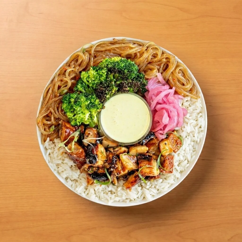 Teriyaki Zen Bol: Jasmine rice and Asian sweet potato noodles, topped with garlic broccoli, teriyaki chicken, pickled red onions, and finished with ginger turmeric dressing.